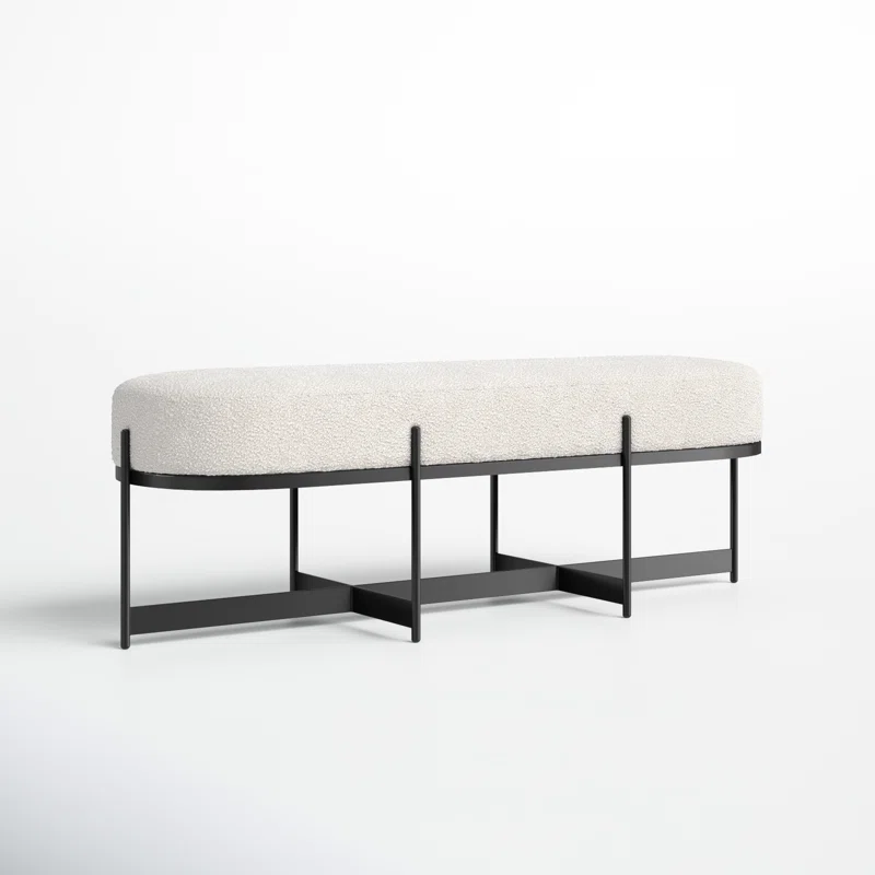 A bench featuring a sleek black frame complemented by a soft white cushion, ideal for outdoor or indoor seating