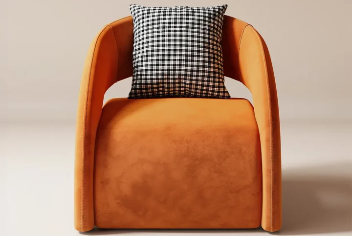 This lounge chair exudes contemporary elegance with its sleek curved armrests and plush velvety upholstery in a warm inviting hue. The minimalist design is complemented