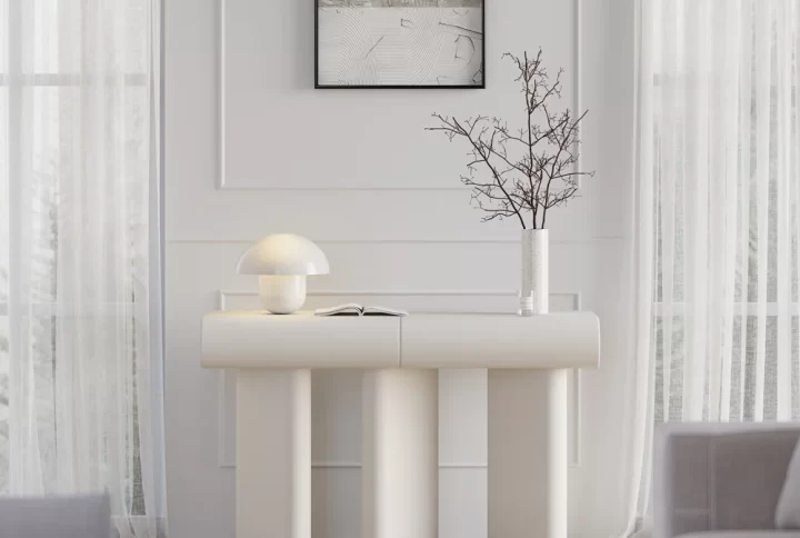 A white console table featuring a stylish lamp on top, elegantly enhancing the room's decor