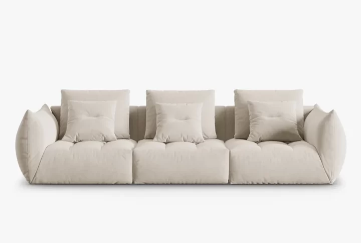 A contemporary sofa adorned with decorative pillows, showcasing a stylish and comfortable living space.