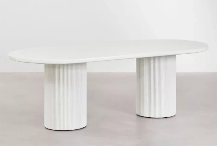 A white Dining table supported by two white legs, creating a minimalist and clean aesthetic in the space