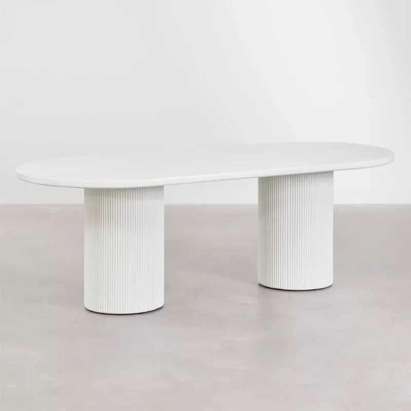 A white Dining table supported by two white legs, creating a minimalist and clean aesthetic in the space
