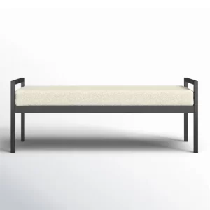 Modern bench with black frame and beige cushion, isolated on white background.