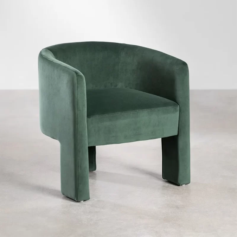 A green velvet Dining chair featuring a gracefully curved back, adding elegance to any interior space