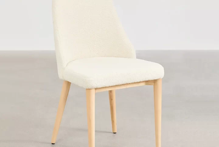 A dining table with a chair set in a well-lit room, showcasing a cozy and inviting atmosphere for meals