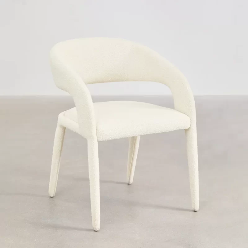 A white chair featuring a gracefully curved back and arms, designed for comfort and elegance in any setting