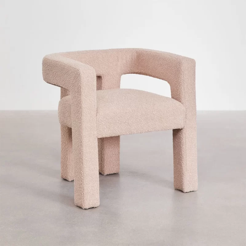 A Pink chair featuring a gracefully curved back and arms, designed for comfort and elegance in any setting