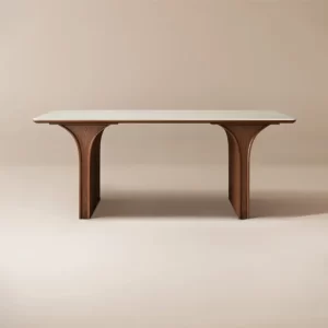 A simple wooden Dining table with ornate legs against a neutral background.