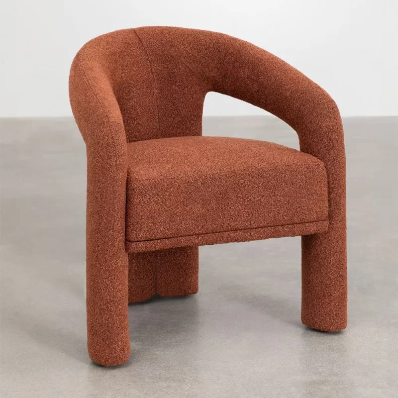 A simple chair and table set against a backdrop of white walls in a well-lit room