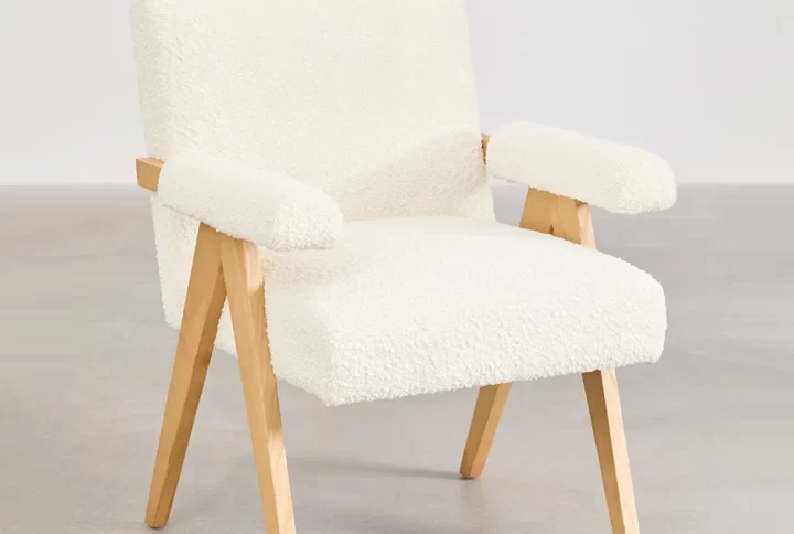 A rustic wooden table and chair situated in a room, emphasizing a minimalist design and a comfortable environment.