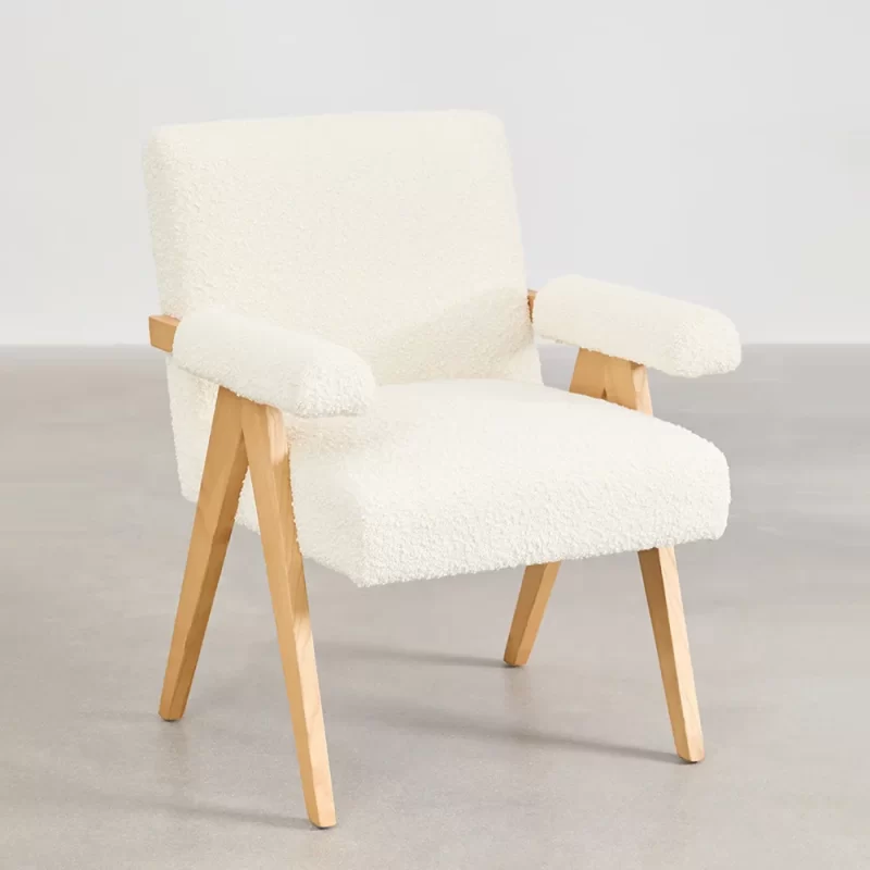 A rustic wooden table and chair situated in a room, emphasizing a minimalist design and a comfortable environment.