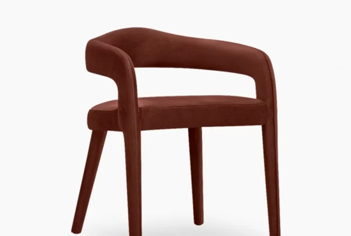 A dark brown velvet armchair, showcasing a luxurious and elegant design, perfect for any sophisticated interior.