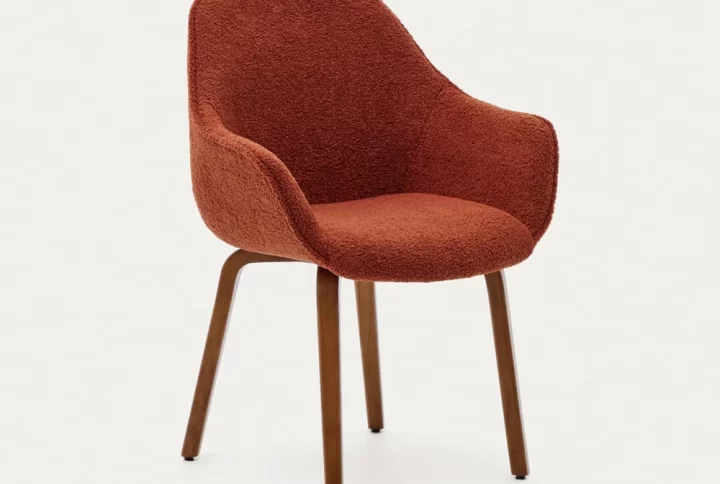 A chair featuring a red upholstered seat supported by elegant wooden legs, showcasing a blend of comfort and style