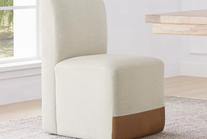 A contemporary chair featuring a tan seat and back, showcasing a sleek and minimalist design suitable for any space