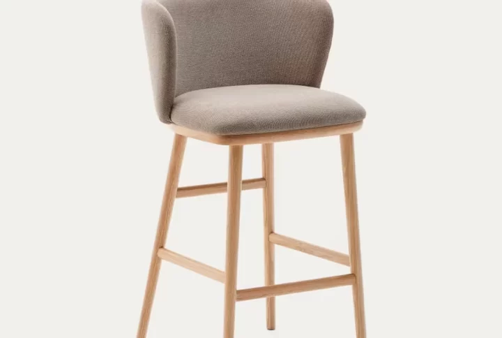 A wooden-framed stool featuring a comfortable upholstered seat, ideal for various settings