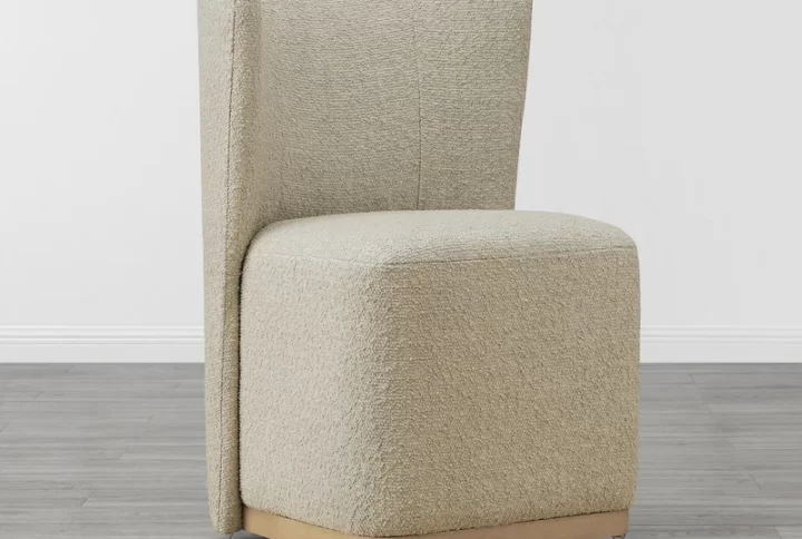 A modern beige dining chair featuring elegant gold legs, combining style and comfort for any dining space