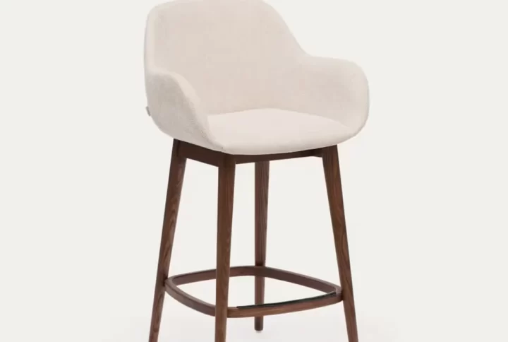 A wooden-framed stool featuring a comfortable upholstered seat, ideal for various settings