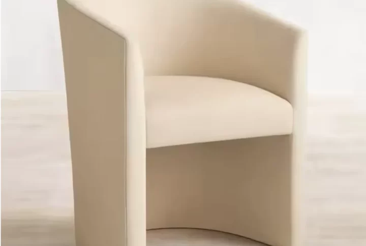 A modern beige dining chair featuring elegant gold legs, combining style and comfort for any dining space