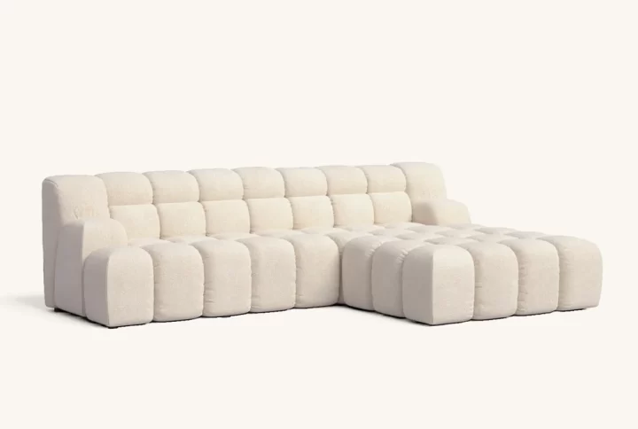 A modern white sectional couch featuring a comfortable chaise for relaxation and stylish living room decor.