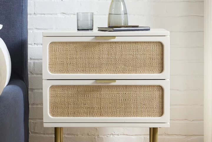 A stylish white and gold nightstand featuring two spacious drawers for storage and organization