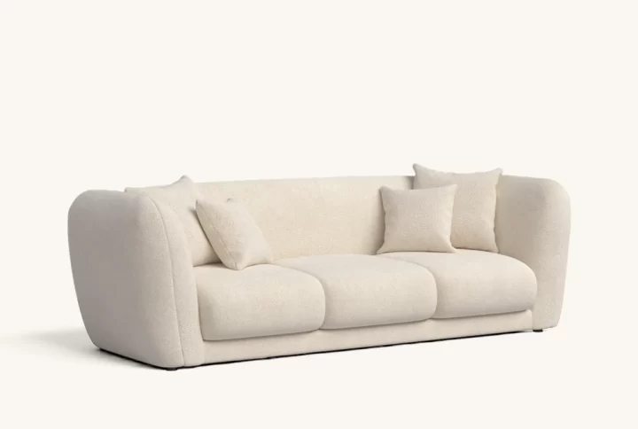 A white couch adorned with decorative pillows, creating a cozy and inviting living space.