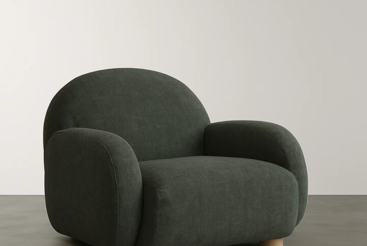 Dezira Lounge Chair with curvy oversized silhouette and walnut cylinder legs styled in modern living room