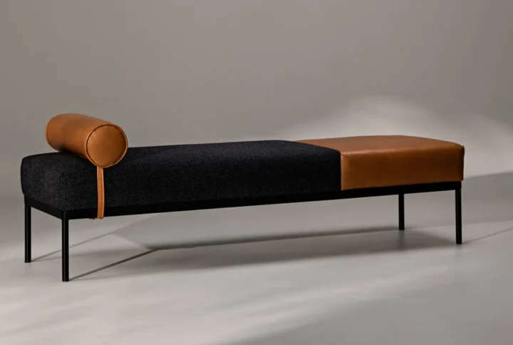 Linen & Faux Leather Chaise Lounge with iron black legs and bolster cushion styled in modern living room