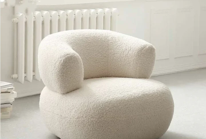 Reya Bouclé Armchair with wooden frame and plush bouclé upholstery styled in modern living room