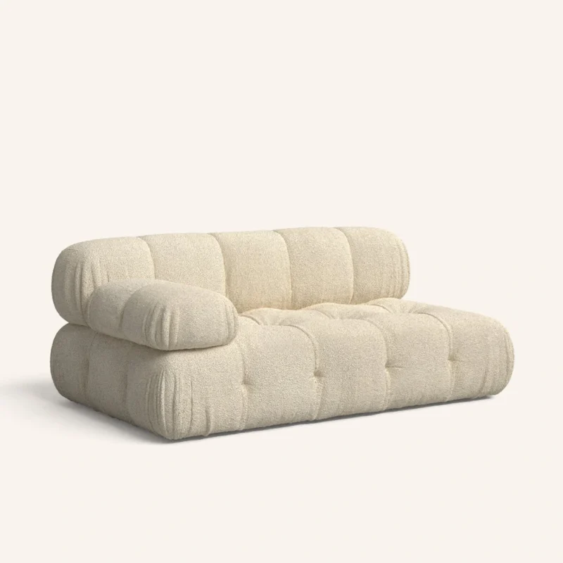 A couch featuring a white cushion resting on its surface