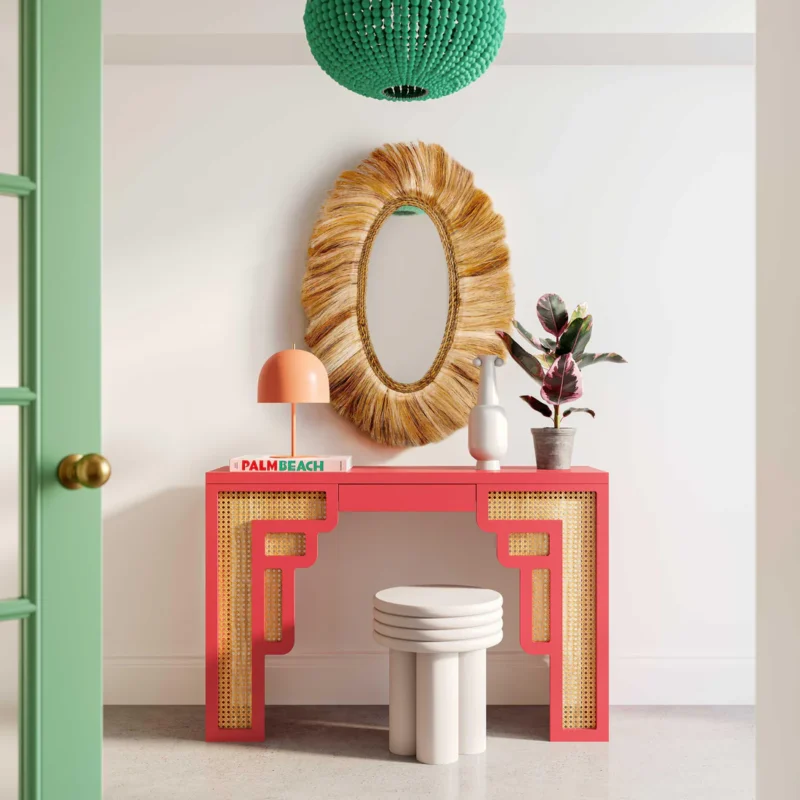 A bright green console table with a mirror above it and a matching stool beside it