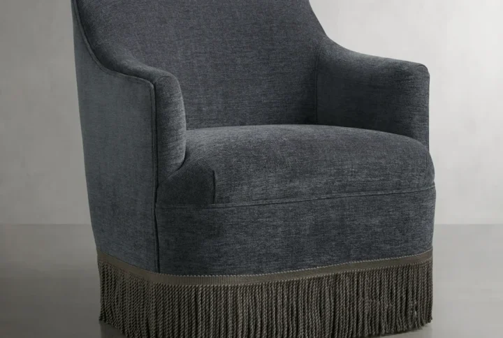 Bellamy Lounge Chair with curved silhouette and fringe detailing styled in vintage-inspired living room