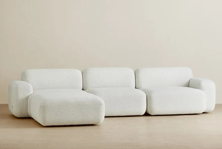 Add sculptural elegance to your living space with this curved light-gray velvet sectional. Crafted for comfort and style, its plush seating and sleek black base create a striking visual balance. The gentle curve softens the minimalist aesthetic, while the neutral palette complements modern interiors with a luxurious, understated vibe.Soft curves, bold contrast—this velvet sectional makes minimalist living effortlessly chic. Let me know if you'd like variations tailored for platforms like Pinterest or your product page!