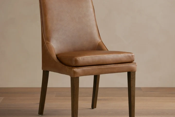 Aluna Faux Leather Dining Side Chair with curved backrest and hand-finished hardwood frame styled in modern UAE dining room