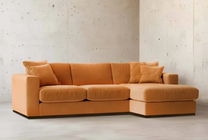 Savoy Luxe L-Shaped Velvet Sofa in burnt-orange velvet with chaise lounge styled in loft-inspired living room