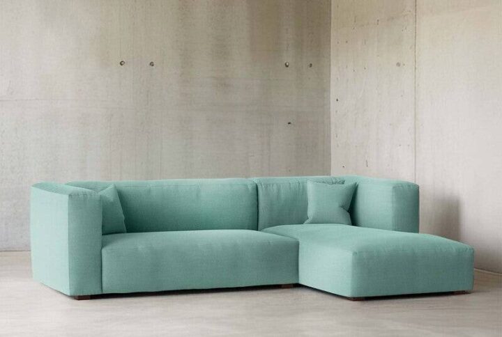 Modern Mint Green L-Shaped Sectional Sofa with chaise lounge and deep cushions styled in minimalist living room