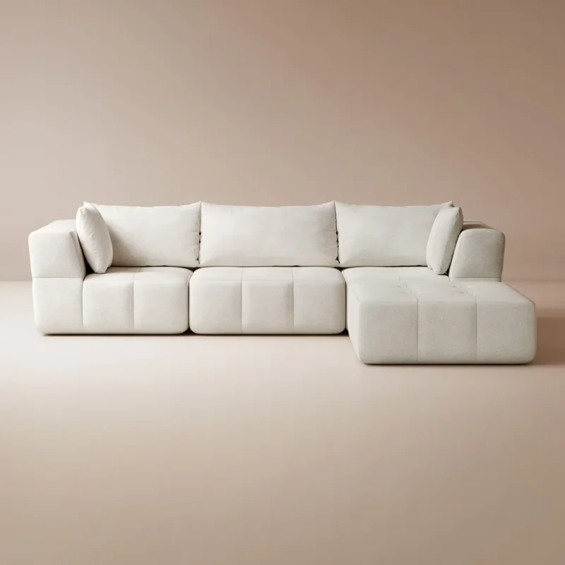 A cozy living room featuring a white couch and a wooden table, creating a warm and inviting atmosphere.