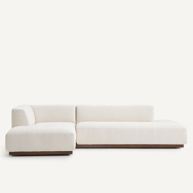 Jacopo Sofa with armless silhouette, deep seat, and floating beechwood legs in a modern living room.