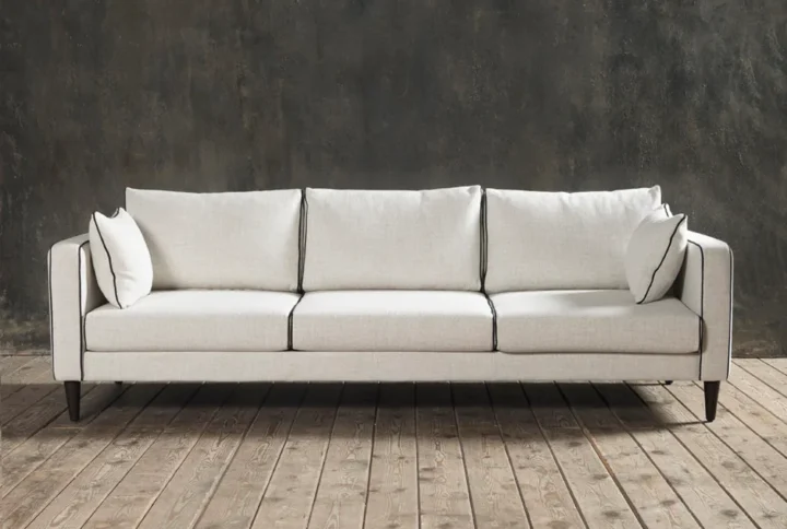 Sofa Blanc 3-seater with sculptural silhouette, contrast piping, and minimalist French-inspired design.