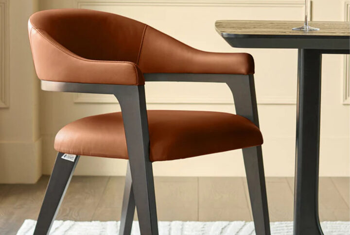 Tan leather dining chair with black legs